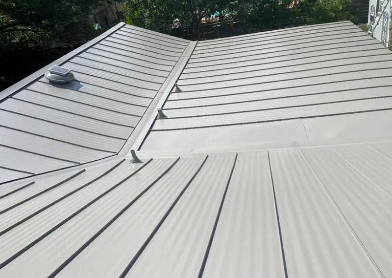 Solar attic fan installed on a metal roof for Roof Ventilation in Triangle